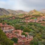 high-angle-shot-of-brown-buildings-near-mountains